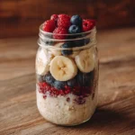 Fruit overnight oats WW friendly in a mason jar with berries