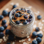 Nut free overnight oats topped with blueberries and sunflower seed butter
